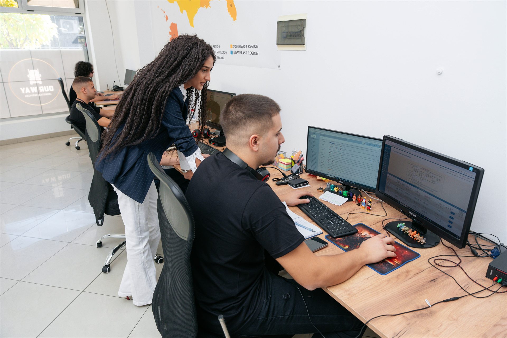 Colleagues reviewing information together at a dispatch workstation