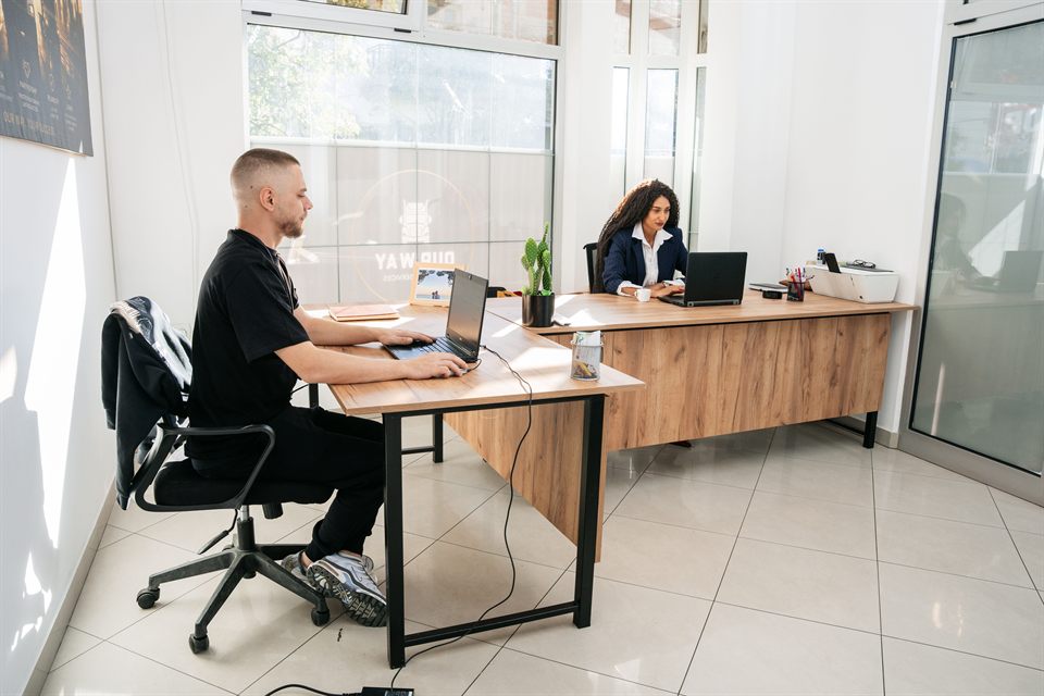 Colleagues working in the bright OUR WAY LOGISTICS office