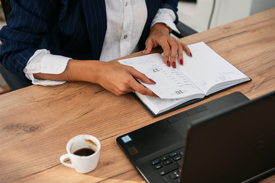 Notes, paperwork and a laptop on an office desk